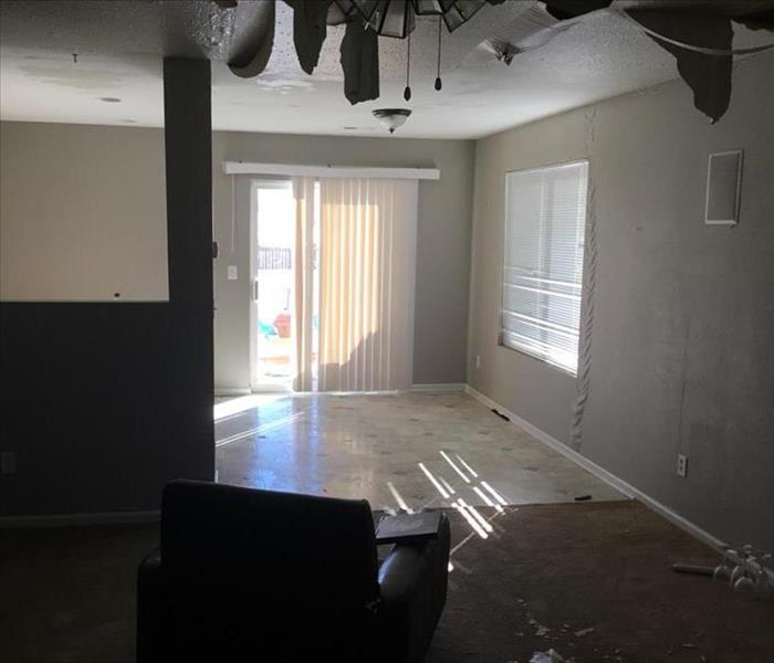 Living room with a collapsed ceiling due to a water leak