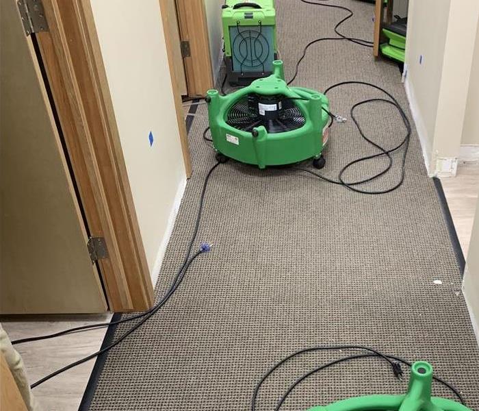 SERVPRO drying equipment setup in the hallway to dry the carpet