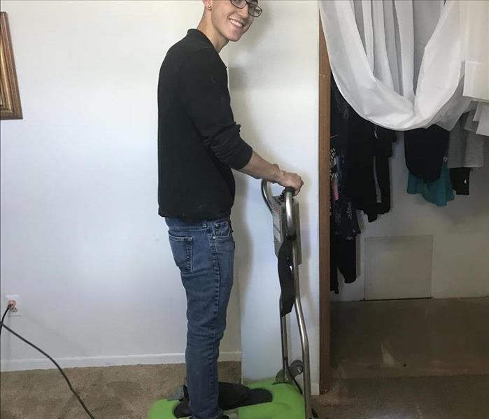 SERVPRO technician extracting water from the carpet