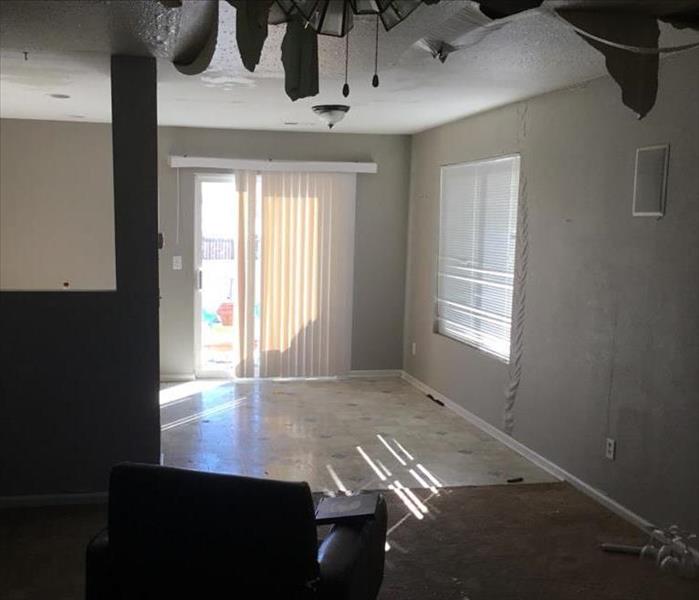 A water leak causes water damage in the ceiling and walls of a living room