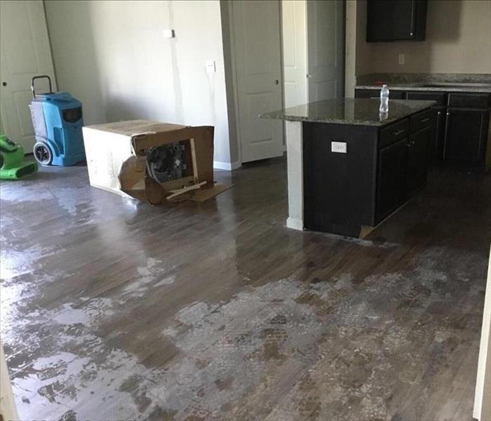 Water on the floor of an apartment from a kitchen leak