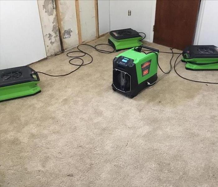 Removing water from the carpet with air movers