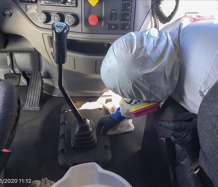 SERVPRO tech in PPE cleaning a business