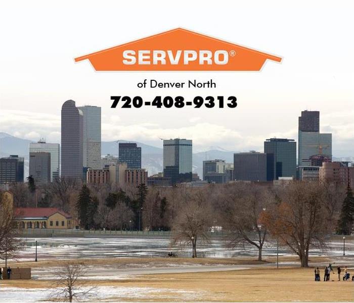 Downtown Denver, Colorado is shown with snow melting in a nearby park.