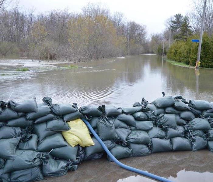 Flood waters outside with sandbags setup to prevent flood from spreading