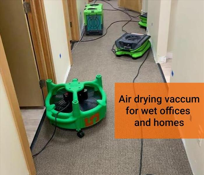 air dryers on a wet carpet in a hallway